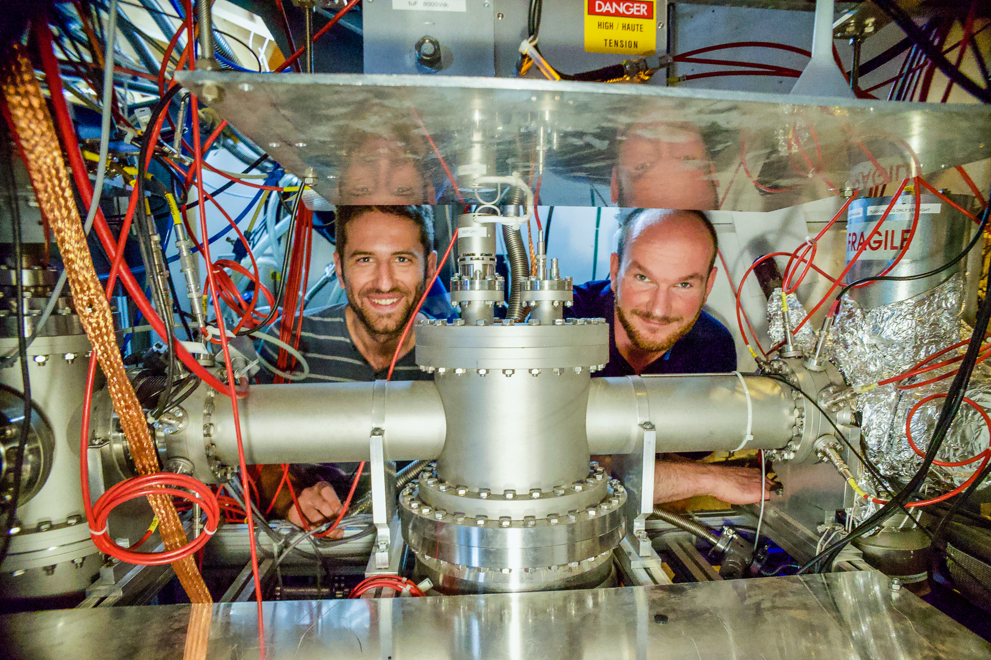 Dinko Atanasov and Frank Wienholtz (on the right) behind the MR-ToF MS component of the ISOLTRAP setup in the ISOLDE experimental hall at CERN, ©Jonas_Karthein.